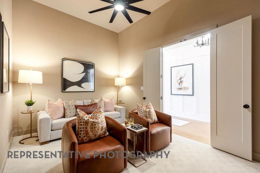 Living room featuring light wood-type flooring and ceiling fan