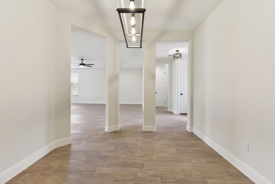 Entrance foyer featuring a ceiling fan, baseboards, and light wood finished floors