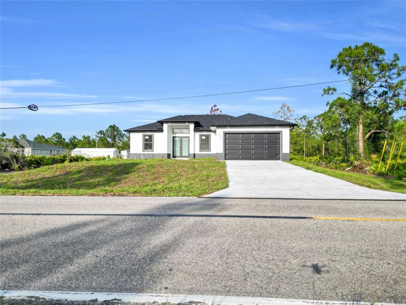 Front exterior of a new home in , Lehigh Acres, FL, highlighting curb appeal (Image 1). Front exterior of a new home in , Lehigh Acres, FL, highlighting curb appeal (Image 1).