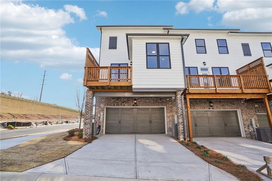 Front exterior of a new home in Palisades Townhomes, Cumming, GA, highlighting curb appeal (Image 1). Front exterior of a new home in Palisades Townhomes, Cumming, GA, highlighting curb appeal (Image 1).