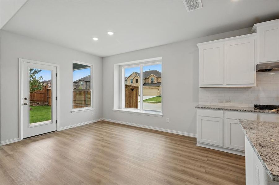 Unfurnished dining area featuring light wood-style flooring, baseboards, and recessed lighting Unfurnished dining area featuring light wood-style flooring, baseboards, and recessed lighting
