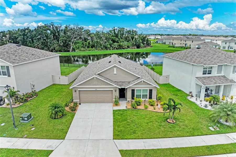Front exterior of a new home in Bella Lago, Parrish, FL, highlighting curb appeal (Image 21).