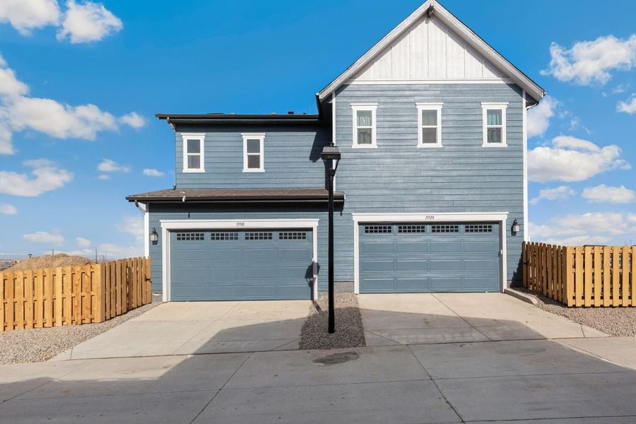 Front exterior of a new home in Turnberry Villas, Commerce City, CO, highlighting curb appeal (Image 2). Front exterior of a new home in Turnberry Villas, Commerce City, CO, highlighting curb appeal (Image 2).