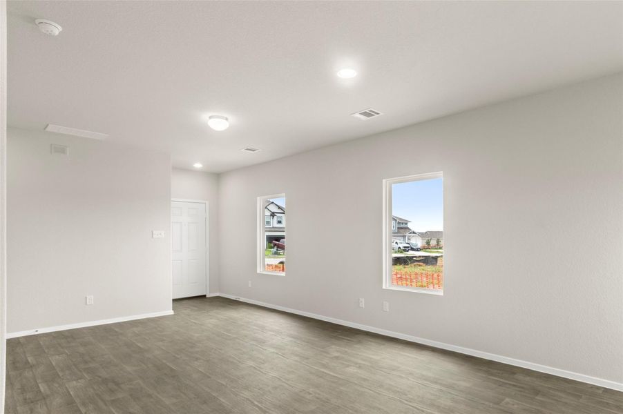 Spare room with dark wood-type flooring and recessed lighting