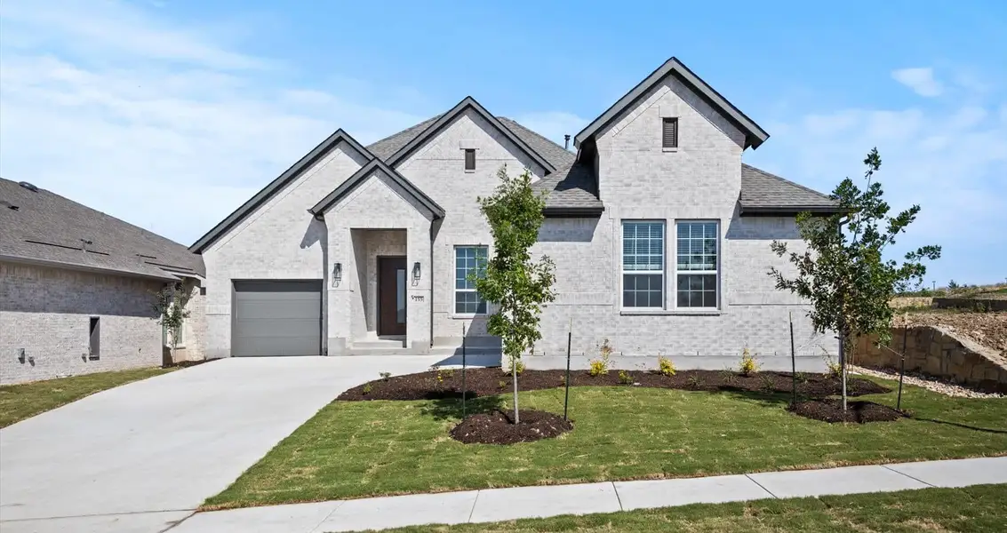 Representative exterior photo of a completed home built from the Farris by Chesmar Homes in 6 Creeks, Kyle, TX (Image 1).