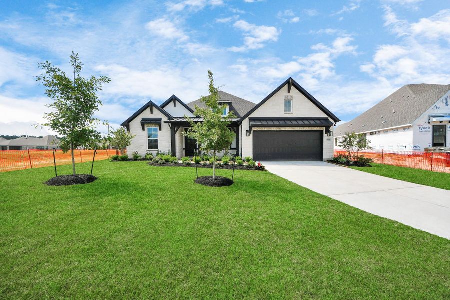 Front exterior of a new home in ARTAVIA: Hilltop Collection, Conroe, TX, highlighting curb appeal (Image 19). Front exterior of a new home in ARTAVIA: Hilltop Collection, Conroe, TX, highlighting curb appeal (Image 19).