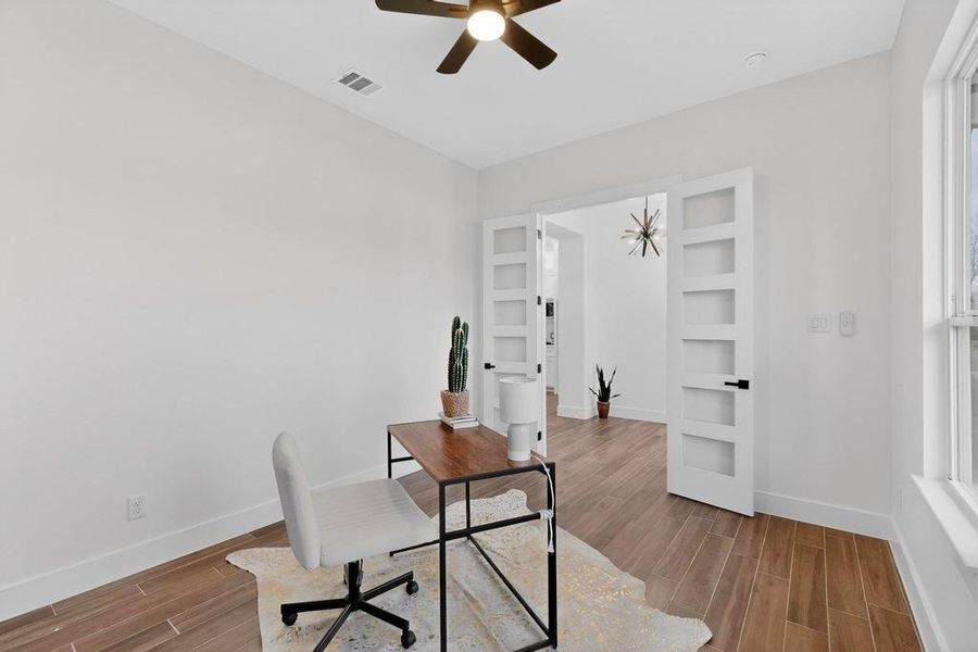 Office space featuring wood tiled floors and a ceiling fan Office space featuring wood tiled floors and a ceiling fan