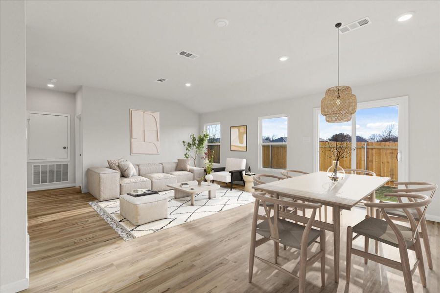 A large living room with a large dining table and a large window.