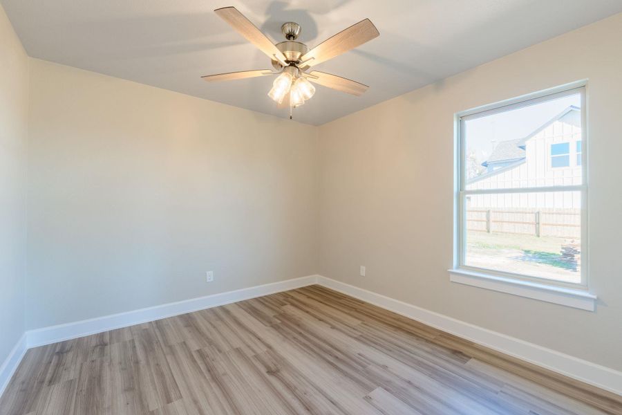 Unfurnished room featuring light wood-style floors and a ceiling fan