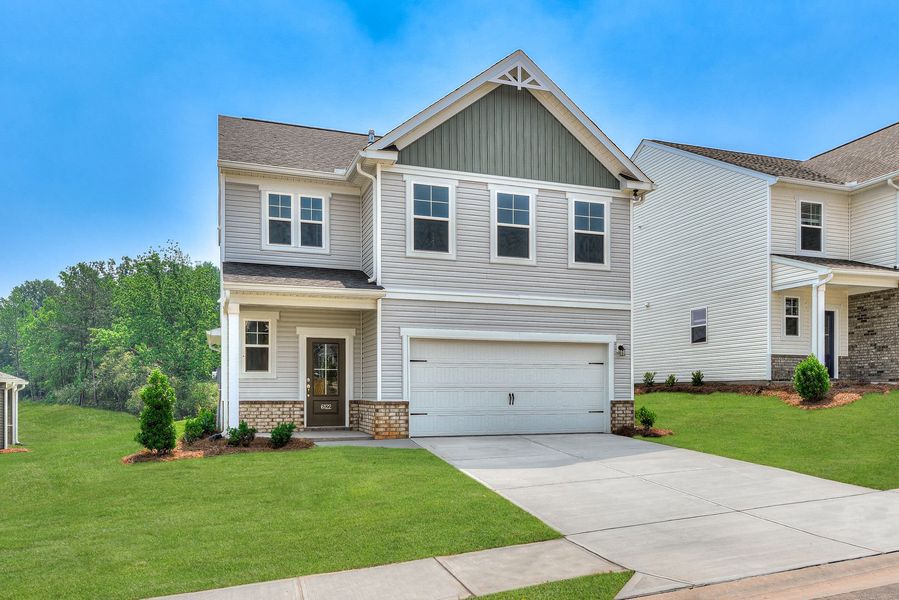 Front exterior of a new home in The Mill at Woodcreek Farms, Elgin, SC, highlighting curb appeal (Image 2). Front exterior of a new home in The Mill at Woodcreek Farms, Elgin, SC, highlighting curb appeal (Image 2).