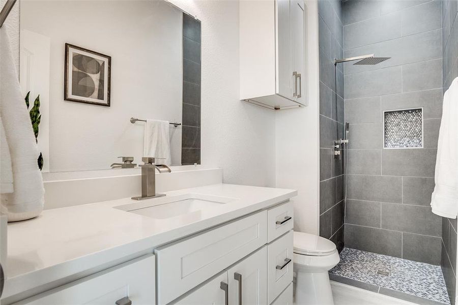 Bathroom with vanity and a stall shower Bathroom with vanity and a stall shower