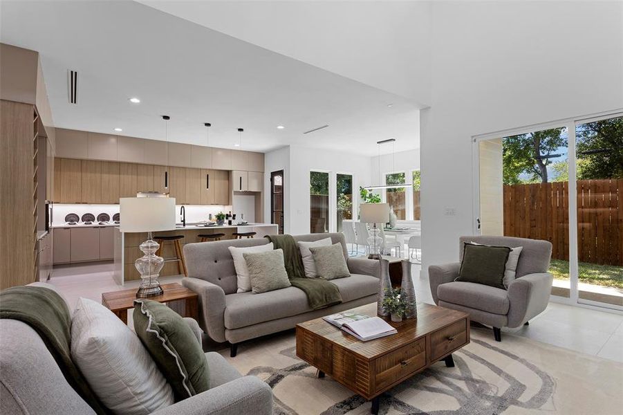 Living room featuring light tile patterned floors, sink, and plenty of natural light