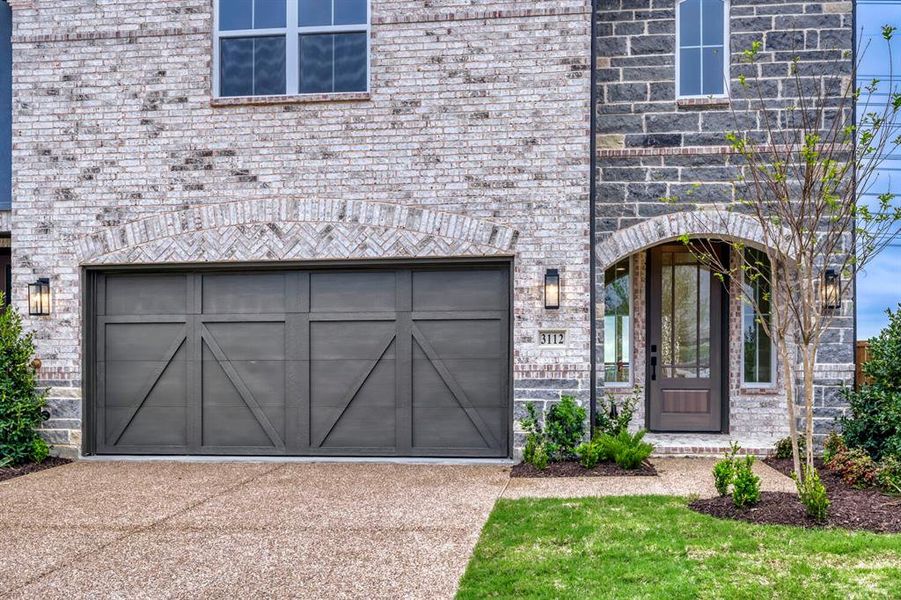 Brick facade with stone accents and a complementary arched entryway