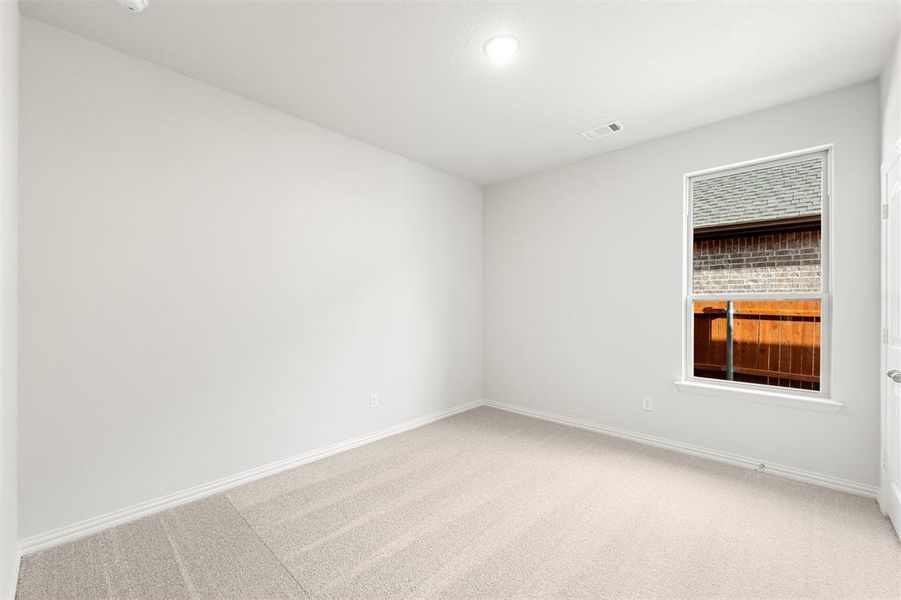 Spare room featuring light colored carpet