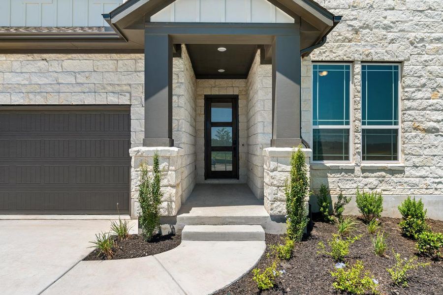 Front exterior of a new home in Lagos Reserve, Manor, TX, highlighting curb appeal (Image 21). Front exterior of a new home in Lagos Reserve, Manor, TX, highlighting curb appeal (Image 21).