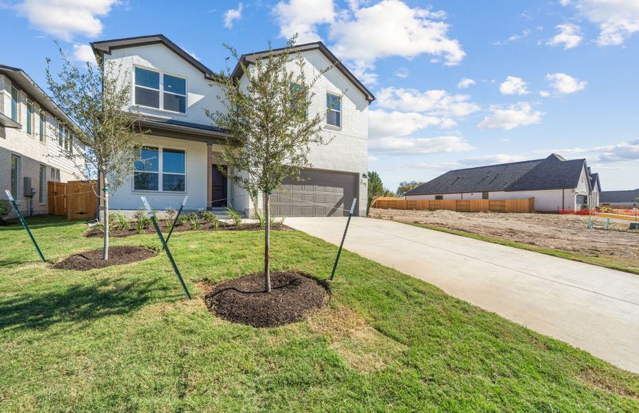 Front exterior of a new home in Woodside, Georgetown, TX, highlighting curb appeal (Image 21). Front exterior of a new home in Woodside, Georgetown, TX, highlighting curb appeal (Image 21).