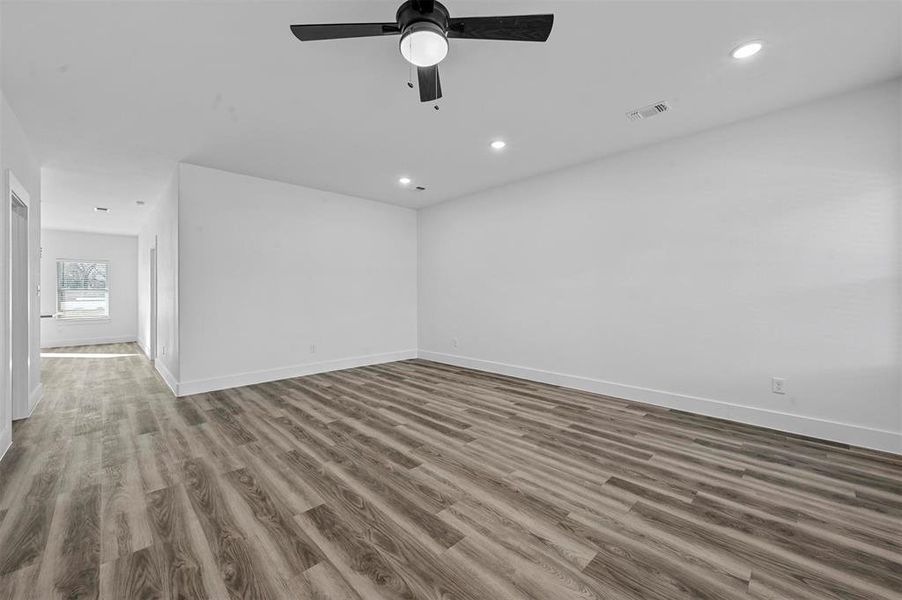 Empty room featuring ceiling fan and hardwood / wood-style floors