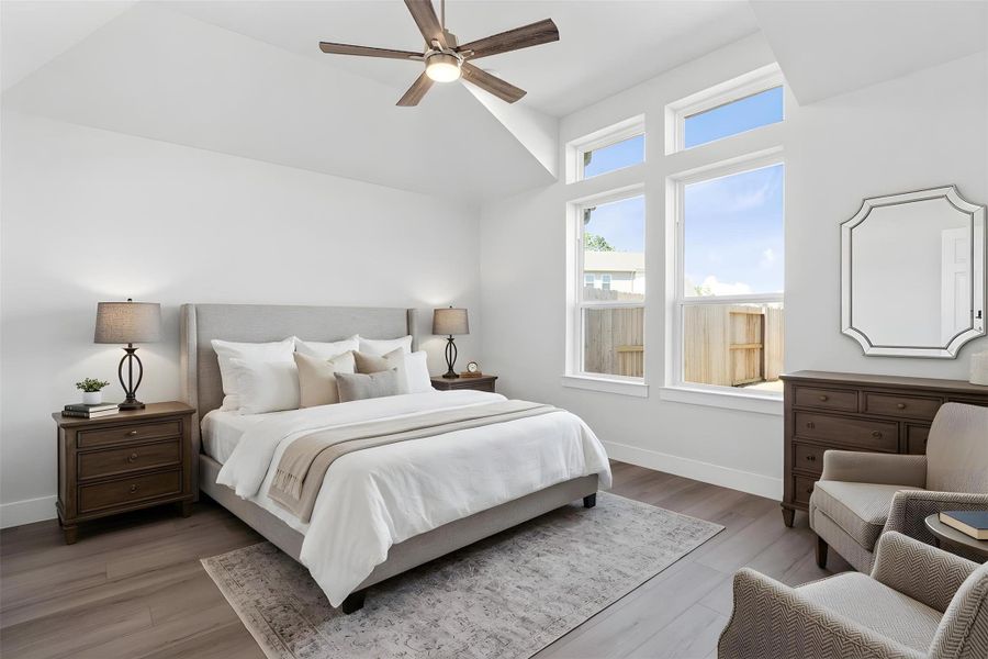 Retreat to this bright and airy primary bedroom, a serene sanctuary designed for ultimate relaxation and comfort. Vaulted ceilings, large windows, stylish LVP flooring, and modern ceiling fan give this room a peaceful space to come home to. *Virtually Staged Retreat to this bright and airy primary bedroom, a serene sanctuary designed for ultimate relaxation and comfort. Vaulted ceilings, large windows, stylish LVP flooring, and modern ceiling fan give this room a peaceful space to come home to. *Virtually Staged