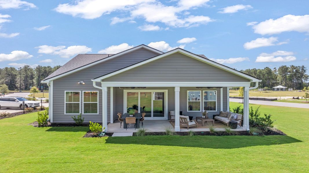 Representative exterior photo of a completed home built from the Traveler by DRB Elevate. in Summerwind Crossing at Lakes of Cane Bay, Summerville, SC (Image 24).