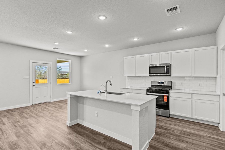A kitchen with white cabinets. A kitchen with white cabinets.