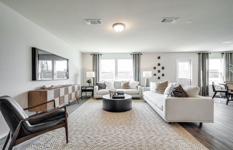 Airy gathering room showcases open concept floorplan *Model representation