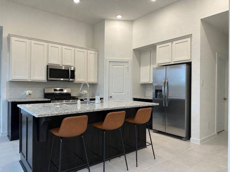 An accommodating farm style stainless steel sink invites any and all kitchen materials, so you still be on kitchen duty and entertain guests in dining and living spaces, beyond. Refrigerator is included. An accommodating farm style stainless steel sink invites any and all kitchen materials, so you still be on kitchen duty and entertain guests in dining and living spaces, beyond. Refrigerator is included.