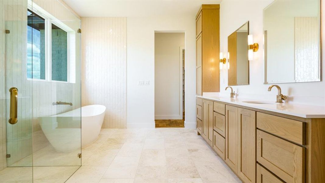 Bathroom with vanity, tile patterned floors, and separate shower and tub