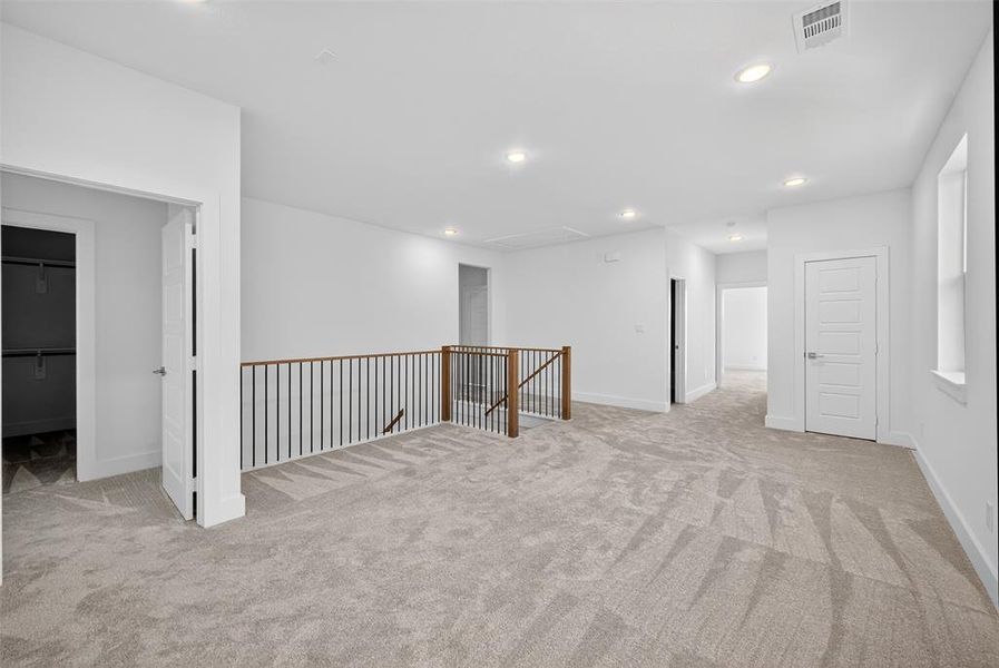 Unfurnished room with light carpet and recessed lighting