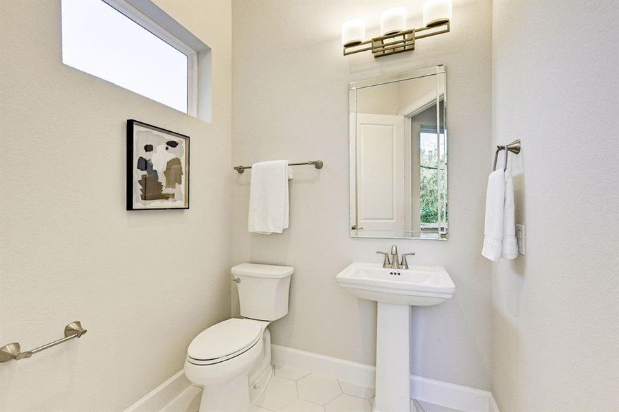 Lovely powder room on the second floor with brushed nickel hardware.