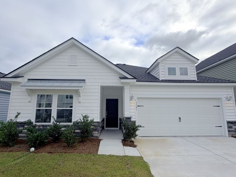 Front exterior of a new home in Wood Stork Landing: Arbor Collection, Ocean Isle Beach, NC, highlighting curb appeal (Image 1).