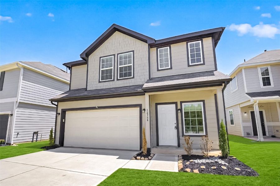 Front exterior of a new home in River's Edge, Conroe, TX, highlighting curb appeal (Image 21). Front exterior of a new home in River's Edge, Conroe, TX, highlighting curb appeal (Image 21).