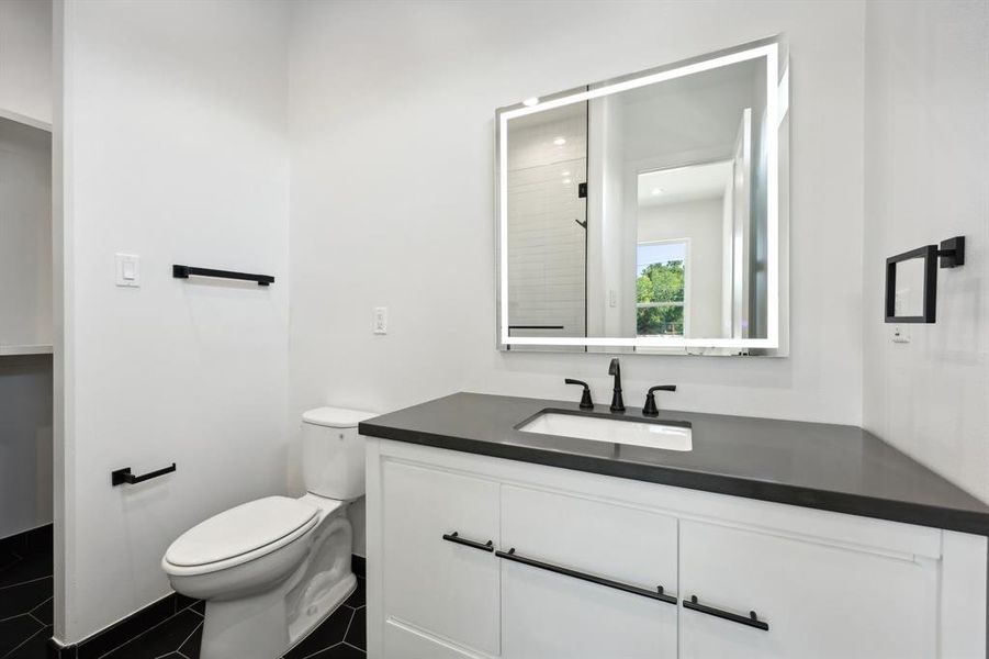 Bathroom with tile patterned floors, vanity, and toilet