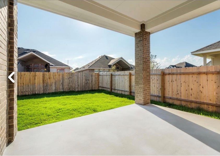Fenced backyard with a patio