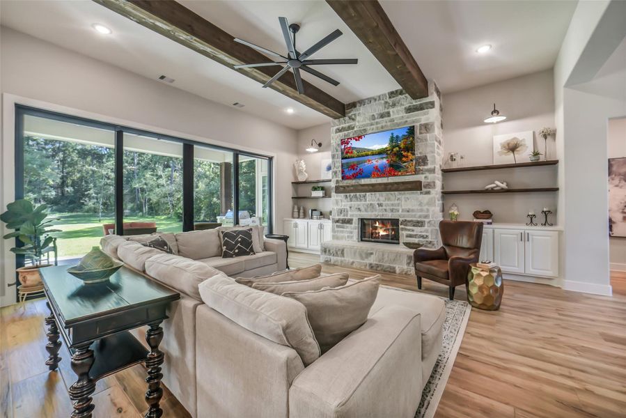 Family room offers a stone fireplace hearth and wood ceiling beams. Family room offers a stone fireplace hearth and wood ceiling beams.