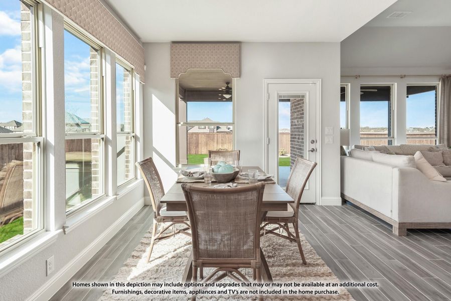Bright dining area with rattan chairs, dark wood table, large windows, and hardwood floors open to living room Bright dining area with rattan chairs, dark wood table, large windows, and hardwood floors open to living room