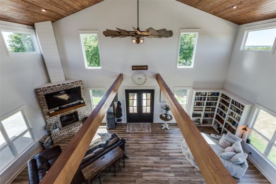 Living room with high vaulted ceiling, wooden ceiling, and dark wood-type flooring Living room with high vaulted ceiling, wooden ceiling, and dark wood-type flooring