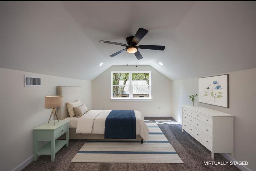 Bedroom featuring vaulted ceiling, a ceiling fan, and dark colored carpet