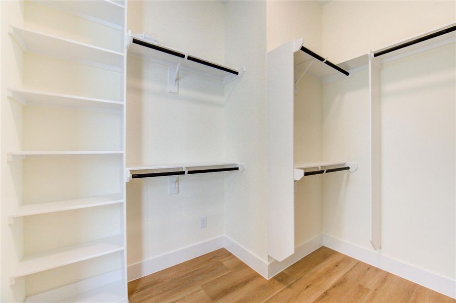 Expansive walk-in closet with ample shelving and hanging space, perfect for organizing your wardrobe. Expansive walk-in closet with ample shelving and hanging space, perfect for organizing your wardrobe.