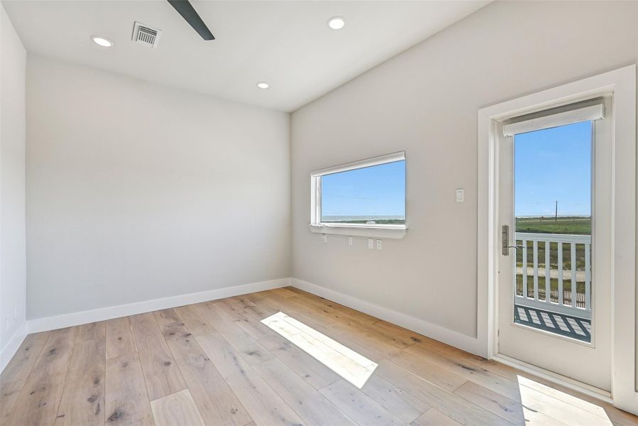 This flexible room easily transforms into a home office, art studio, guest retreat, or media space. Porch access and water views make the room feel bright, inspiring, and connected to the coast.