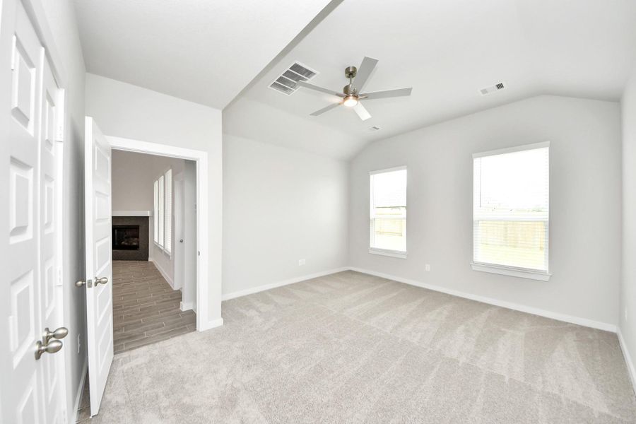 Come and unwind after a long day in this magnificent primary suite! This spacious room features plush carpet, warm paint, high ceilings and large windows with privacy blinds. Sample photo of completed home with similar floor plan. Actual colors and selections may vary. Come and unwind after a long day in this magnificent primary suite! This spacious room features plush carpet, warm paint, high ceilings and large windows with privacy blinds. Sample photo of completed home with similar floor plan. Actual colors and selections may vary.