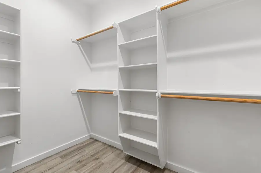Walk in closet featuring wood finished floors