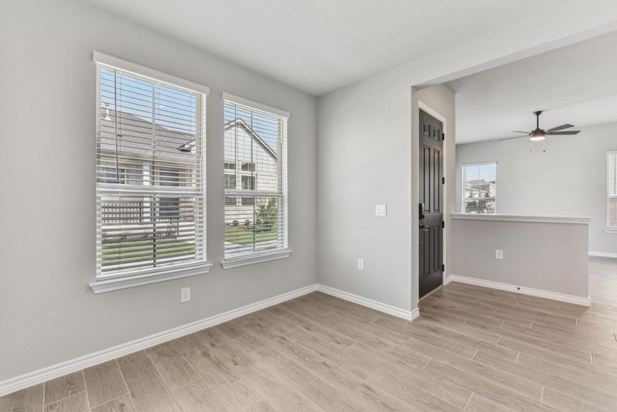 Unfurnished room featuring wood tiled floors and ceiling fan Unfurnished room featuring wood tiled floors and ceiling fan