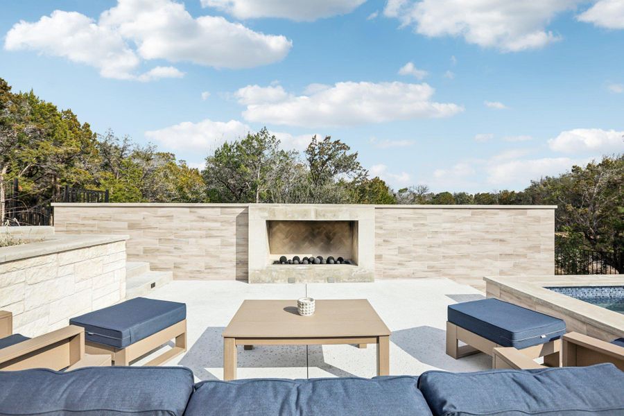 Gather around the outdoor stone fireplace for cozy evenings under the Texas stars.