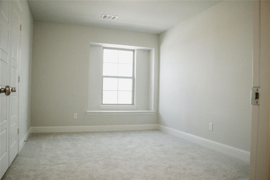 Unfurnished room with light colored carpet