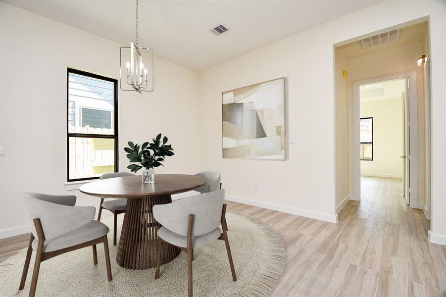 Ideal open kitchen/dining layout with gleaming and luxurious laminate floors. Plenty of space to fit whatever sized dining table you like. This large window flood the home with natural light!