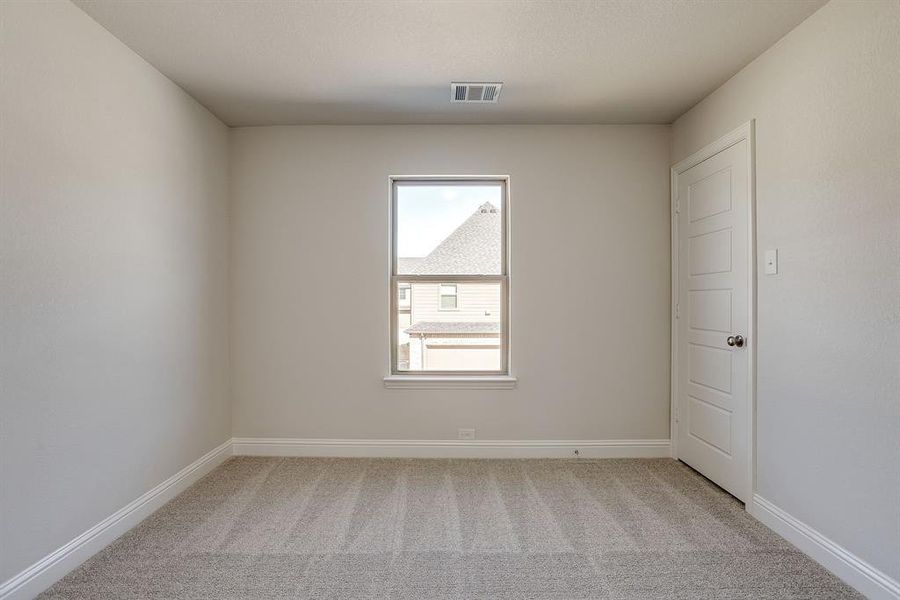 Unfurnished room featuring light carpet and baseboards