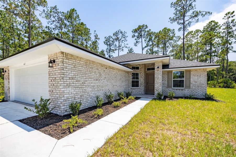 Front exterior of a new home in Palm Coast, Palm Coast, FL, highlighting curb appeal (Image 18).