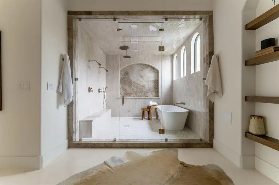Full bathroom featuring a shower stall, tile patterned floors, and a soaking tub