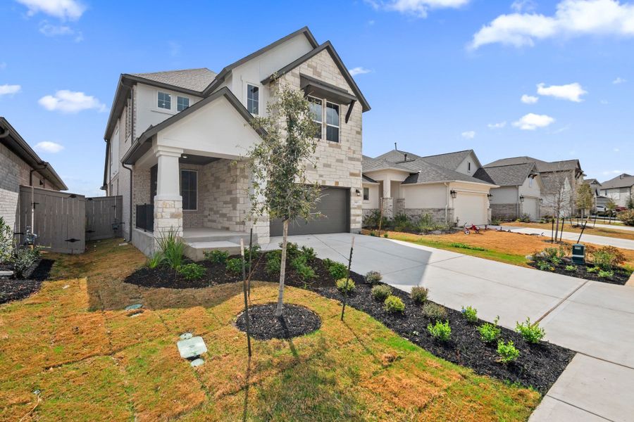 Front exterior of a new home in Flora, Hutto, TX, highlighting curb appeal (Image 24).
