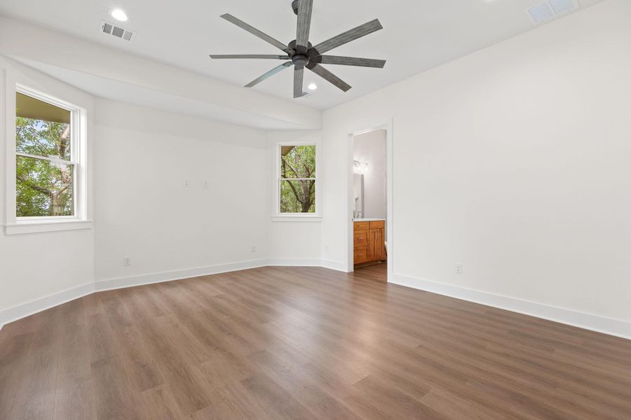 Empty room with healthy amount of natural light, a ceiling fan, baseboards, and recessed lighting Empty room with healthy amount of natural light, a ceiling fan, baseboards, and recessed lighting